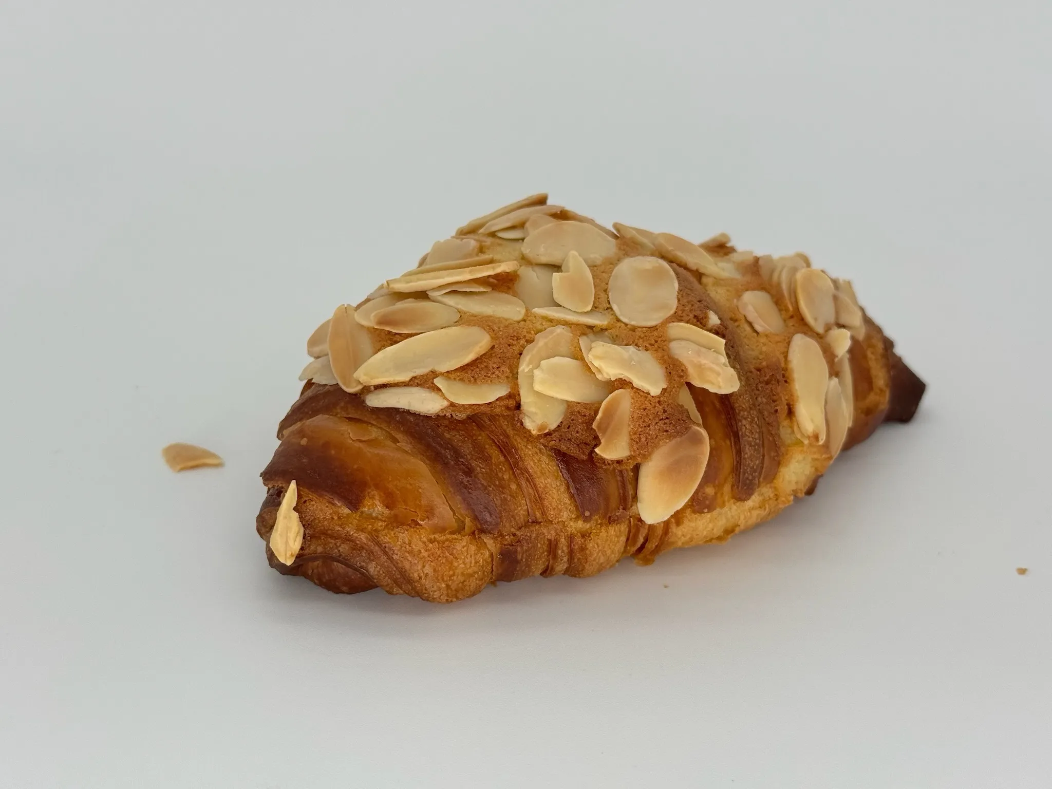Almond Croissant - Twice-baked, filled with luscious almond cream and finished with toasted almonds. A subtle kiss of rum that lingers beautifully.