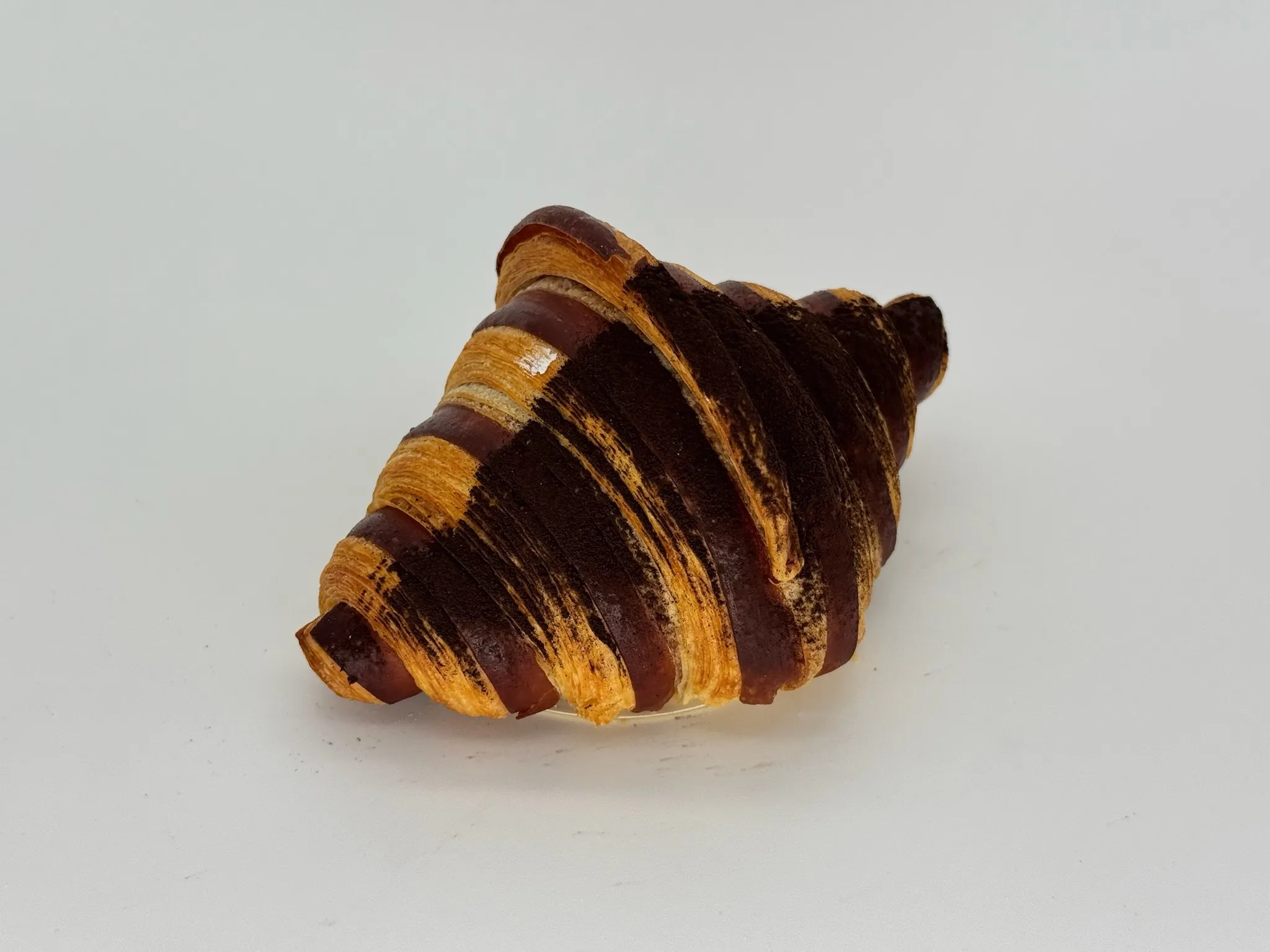 Chocolate Cream Croissant - Golden, flaky croissant generously filled with silky chocolate cream. Deep, smooth, and decadently satisfying from the first bite.