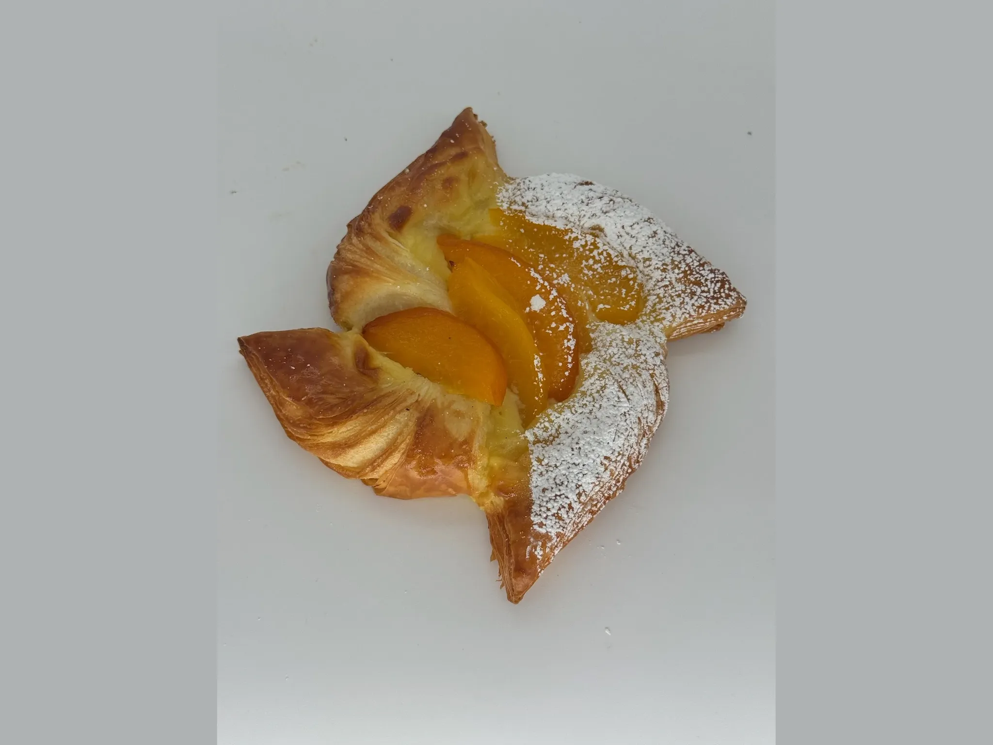Peach Custard Danish - A golden pinwheel of flaky pastry filled with baked vanilla custard and crowned with tender, juicy peaches. Buttery, creamy, and sun-kissed sweet.
